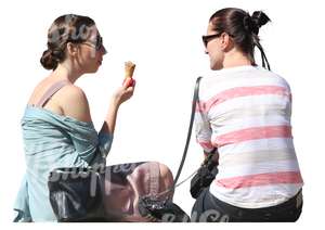 two women sitting and eating icecream