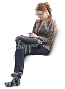 woman sitting and looking at her phone