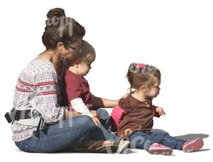 woman with two children sitting on the ground