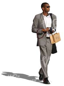 black man in a grey suit walking