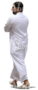 muslim man in a white thobe walking