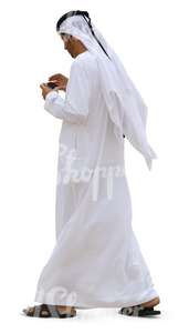 arab man walking and looking at his phone