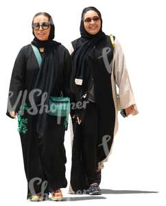 two muslim women walking and smiling