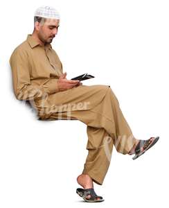 arab man sitting and looking at his phone