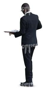 black waiter standing with a tray