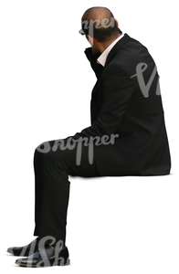 businessman man in a black suit sitting