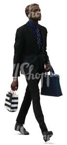 black businessman walking with shopping bags