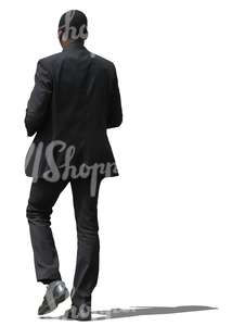 african businessman in a black suit walking