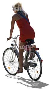 cut out backlit woman riding a bike