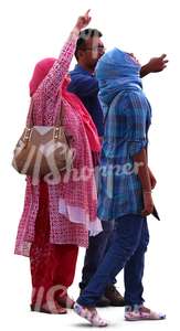 man and two hindu women standing and looking at smth