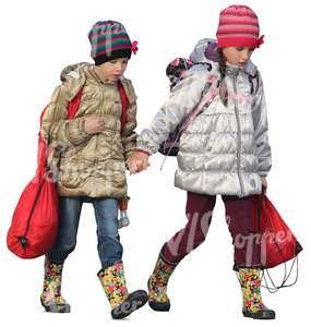 two young girls in autumn coats walking hand in hand