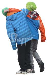 two boys in winter jackets walking playfully