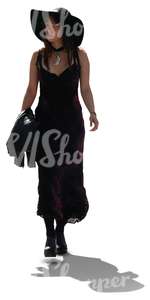 cut out backlit woman in a black dress walking