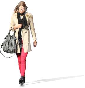young woman in a beige spring coat walking