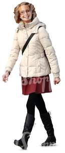 smiling woman in a white puffy coat walking