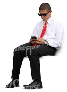 cut out businessman sitting and looking at his phone