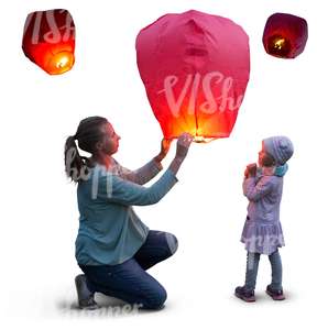 mother and daughter lighting a sky lantern