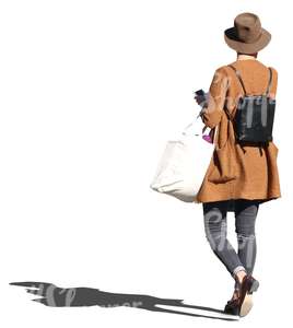 cut out woman in a stylish brown coat walking