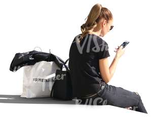 woman sitting and looking at her phone