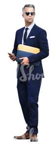 businessman standing with a phone in his hand
