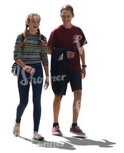 backlit teenage boy and girl walking and talking