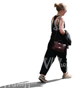 backlit woman walking in summertime