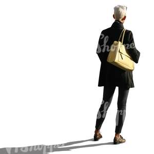 backlit woman with a yellow purse standing