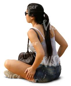 woman with long dark hair sitting on the ground 