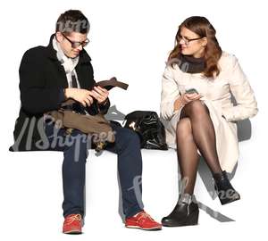 man and woman wearing autumn coats sitting and talking