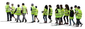 group of students wearing reflector vests walking in line