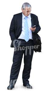 cut out elderly businessman standing and looking at his phone