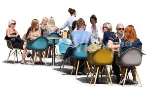 group of people sittnin in a street cafe in summertime