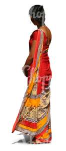 Indian woman wearing a colorful red sari standing