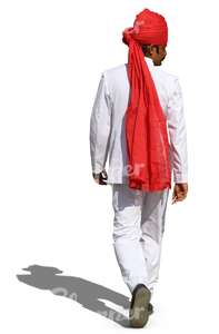 hindu man with a red turban and wearing a white suit walking 