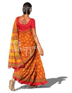 indian woman in a traditional orange sari walking