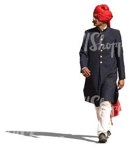 hindu man in a traditional attire and wearing a turban walking