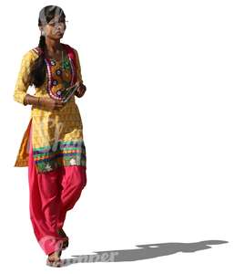 indian woman in a colorful traditional attire walking