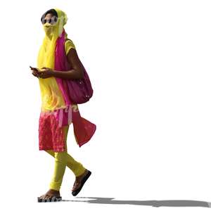 young hindu woman in a clorful outfit and holding a phone walking 