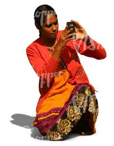 indian woman kneeling and taking a picture