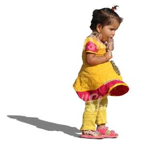 young indian girl standing and eating ice cream
