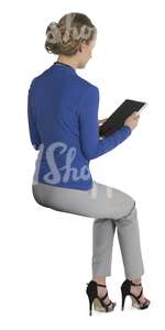 female office worker sitting and lookig at the ipad