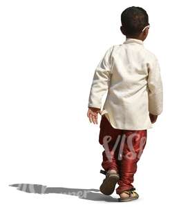 small hindu boy in a fancy costume walking