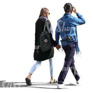 backlit man and woman walking hand in hand