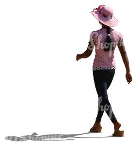 backlit black woman wearing a pink hat walking