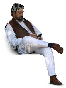 indian man sitting and looking at his phone