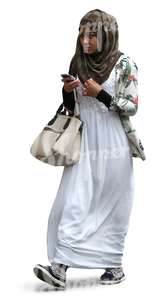 black muslim woman walking with a phone in her hand