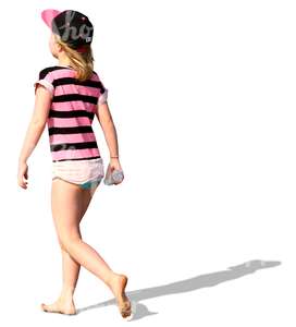 girl walking barefoot on the beach