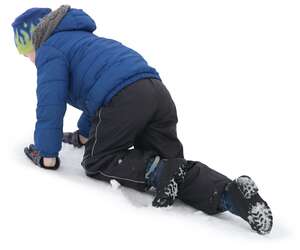 young boy playing in the snow