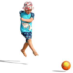 small boy playing with a ball on the beach