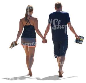 couple walking hand in hand on the beach